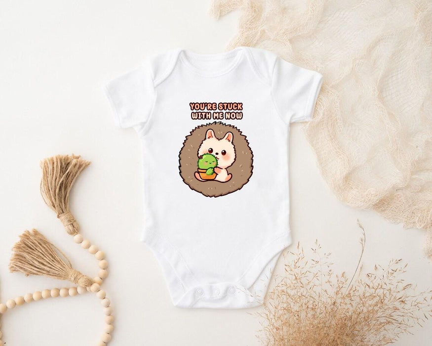 a baby bodysuit with a hedge holding a leaf