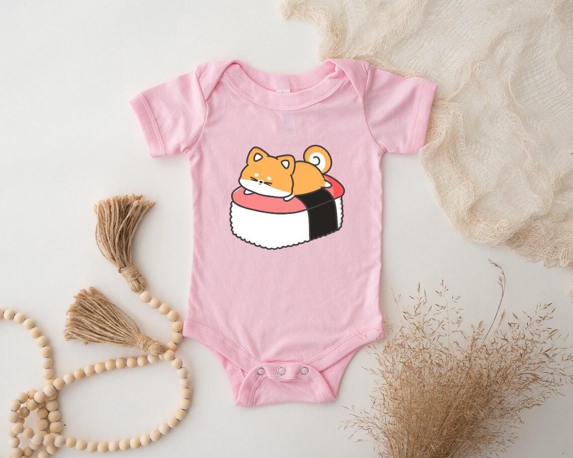 a pink baby bodysuit with a sushi design on it