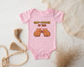 a pink baby bodysuit with two brown bears on it