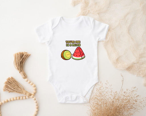 a baby bodysuit with a watermelon and a slice of watermelon