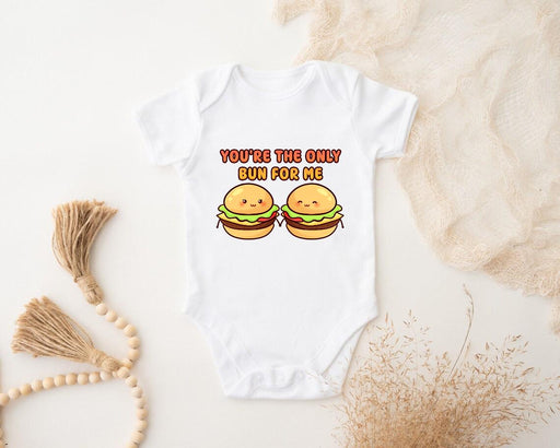 a baby bodysuit with two hamburgers on it