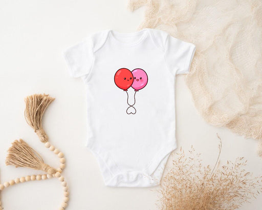 a baby bodysuit with two balloons on it