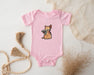 a pink baby bodysuit with a picture of a cat on it