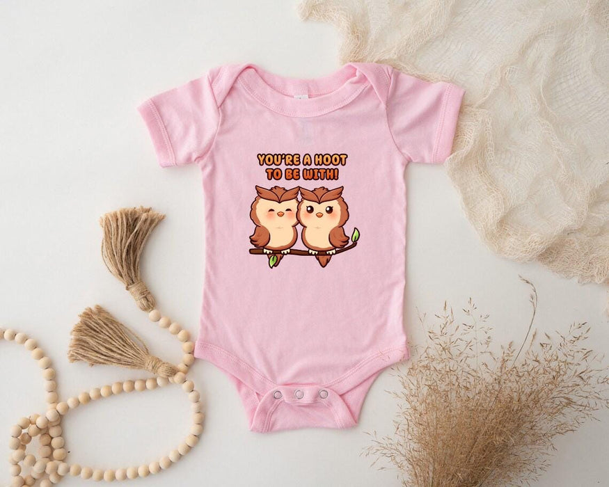 a pink baby bodysuit with two owls on it