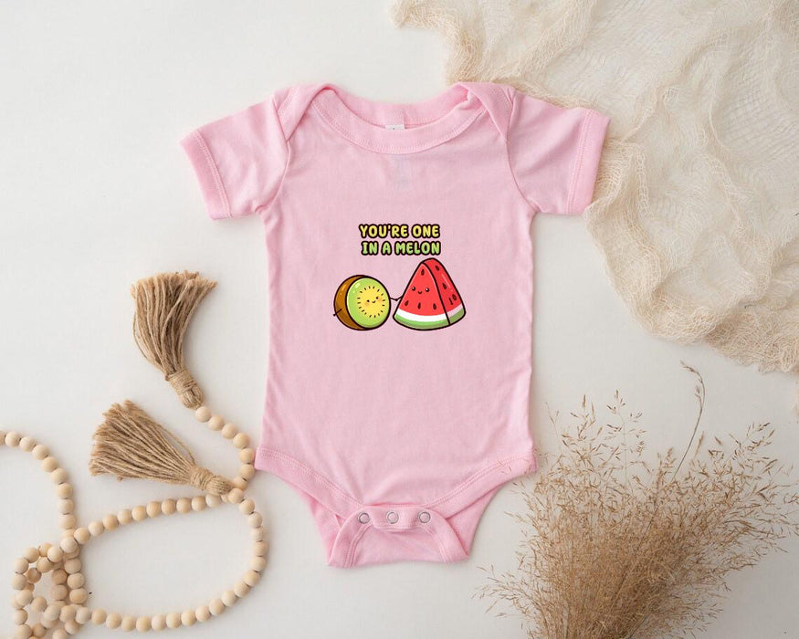 a baby bodysuit with a watermelon and a slice of watermelon