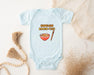 a baby bodysuit with a picture of a bowl of food and a tassel