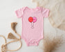 a pink baby bodysuit with two balloons on it