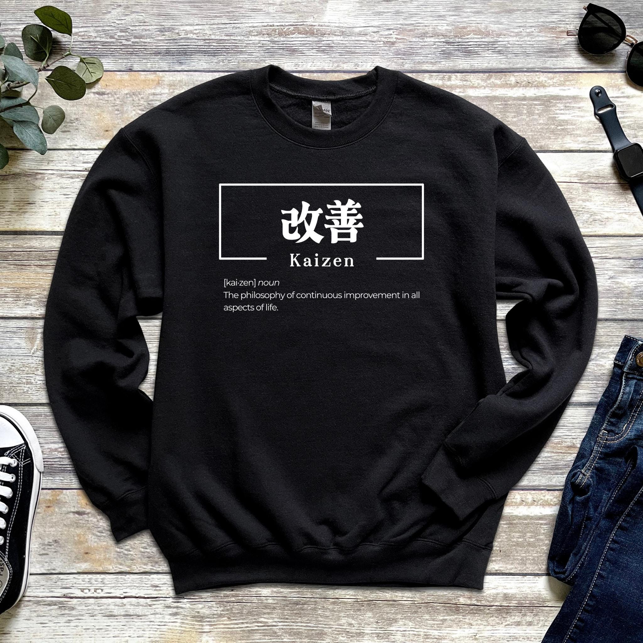a black sweater with a japanese kanji symbol on it