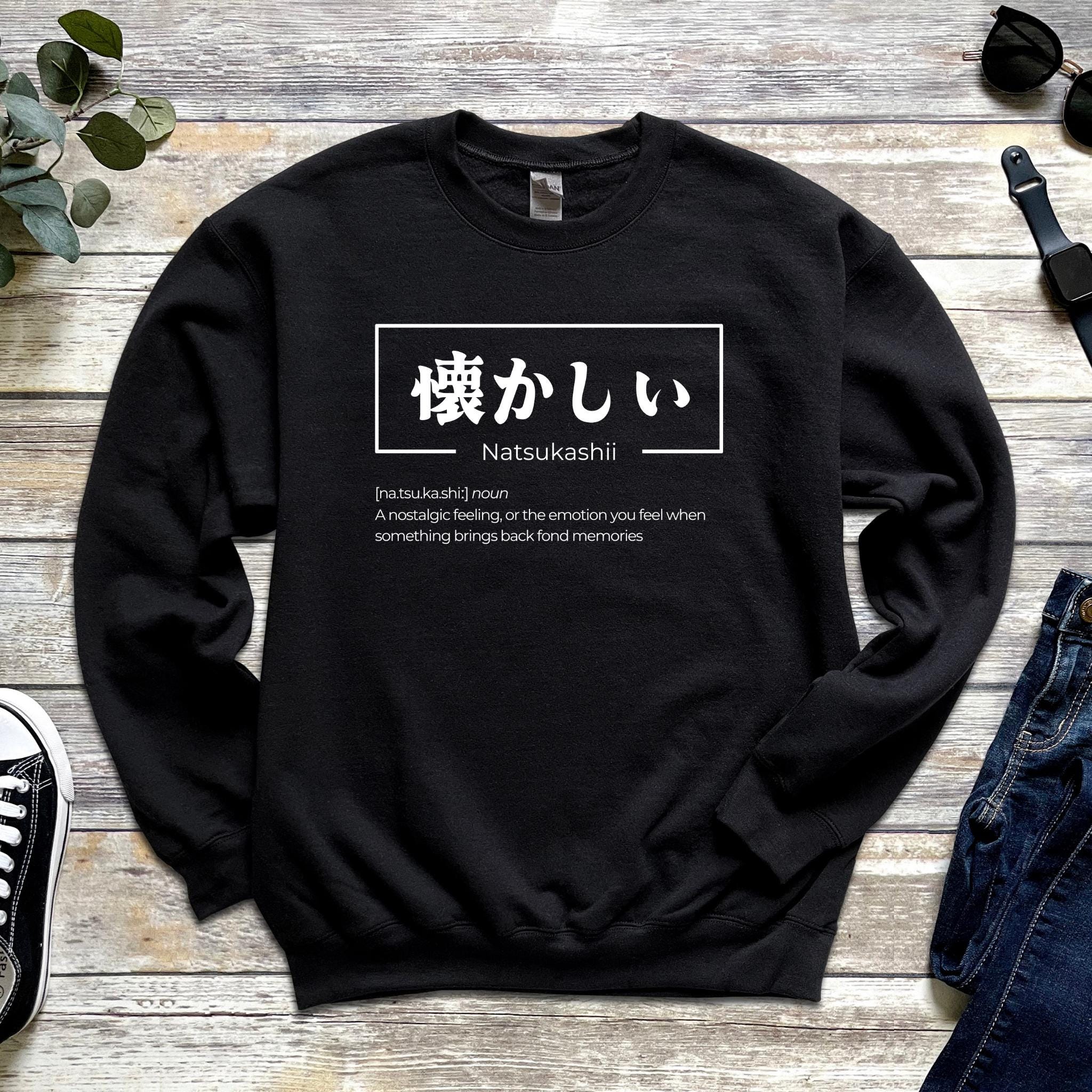 a black sweatshirt with japanese characters on it