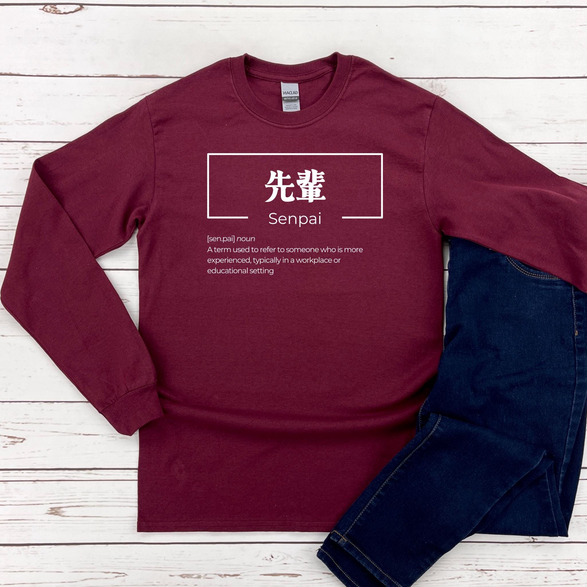 a red shirt with a white sign on it