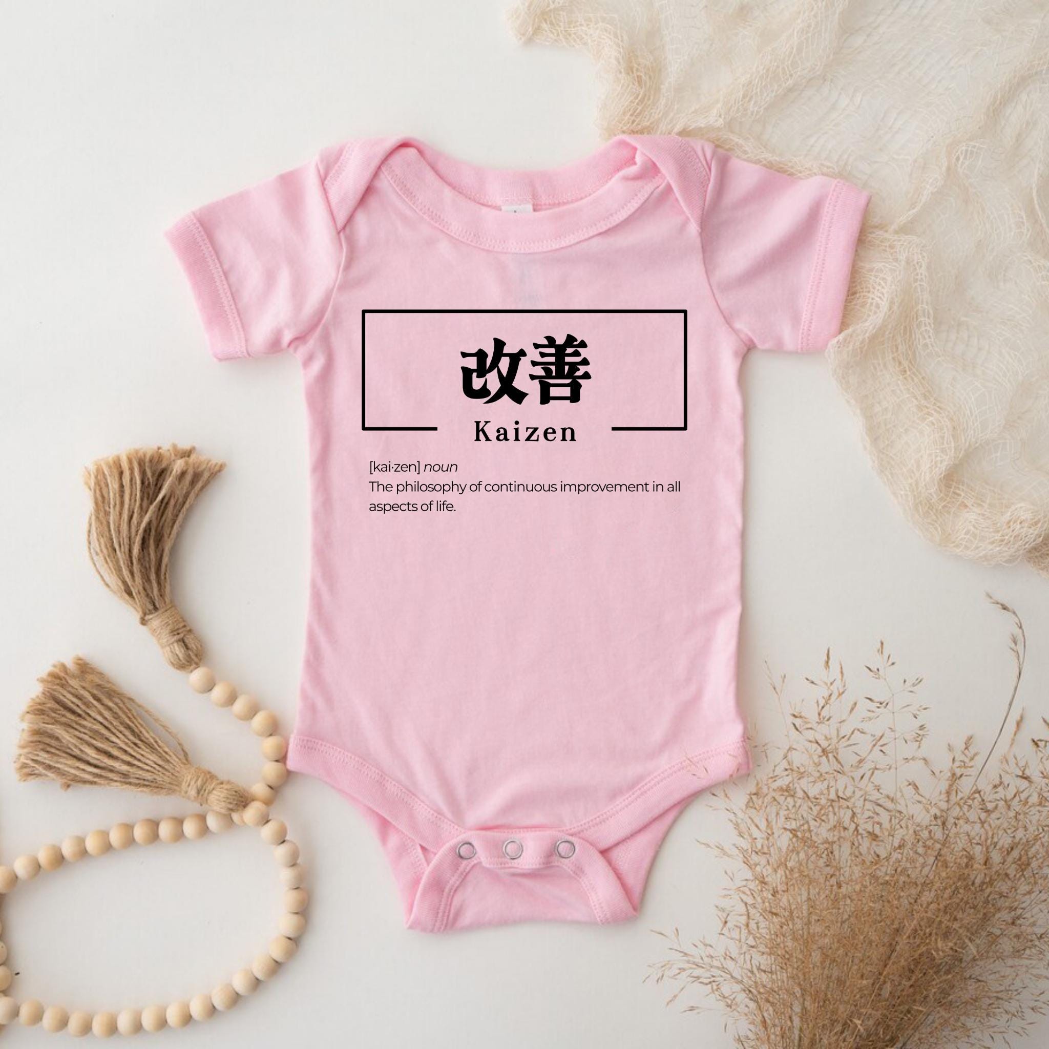 a baby bodysuit with chinese characters on it