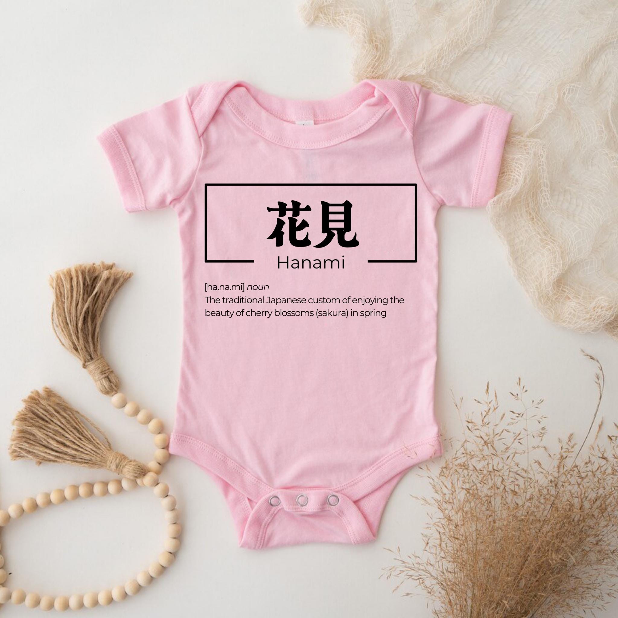 a baby bodysuit with the words hannan written in chinese