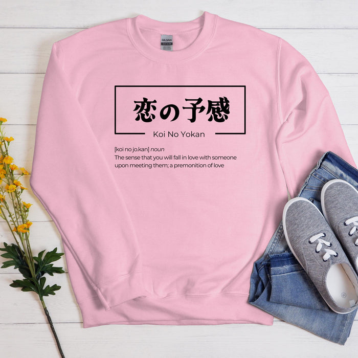 a pink sweatshirt with japanese characters on it