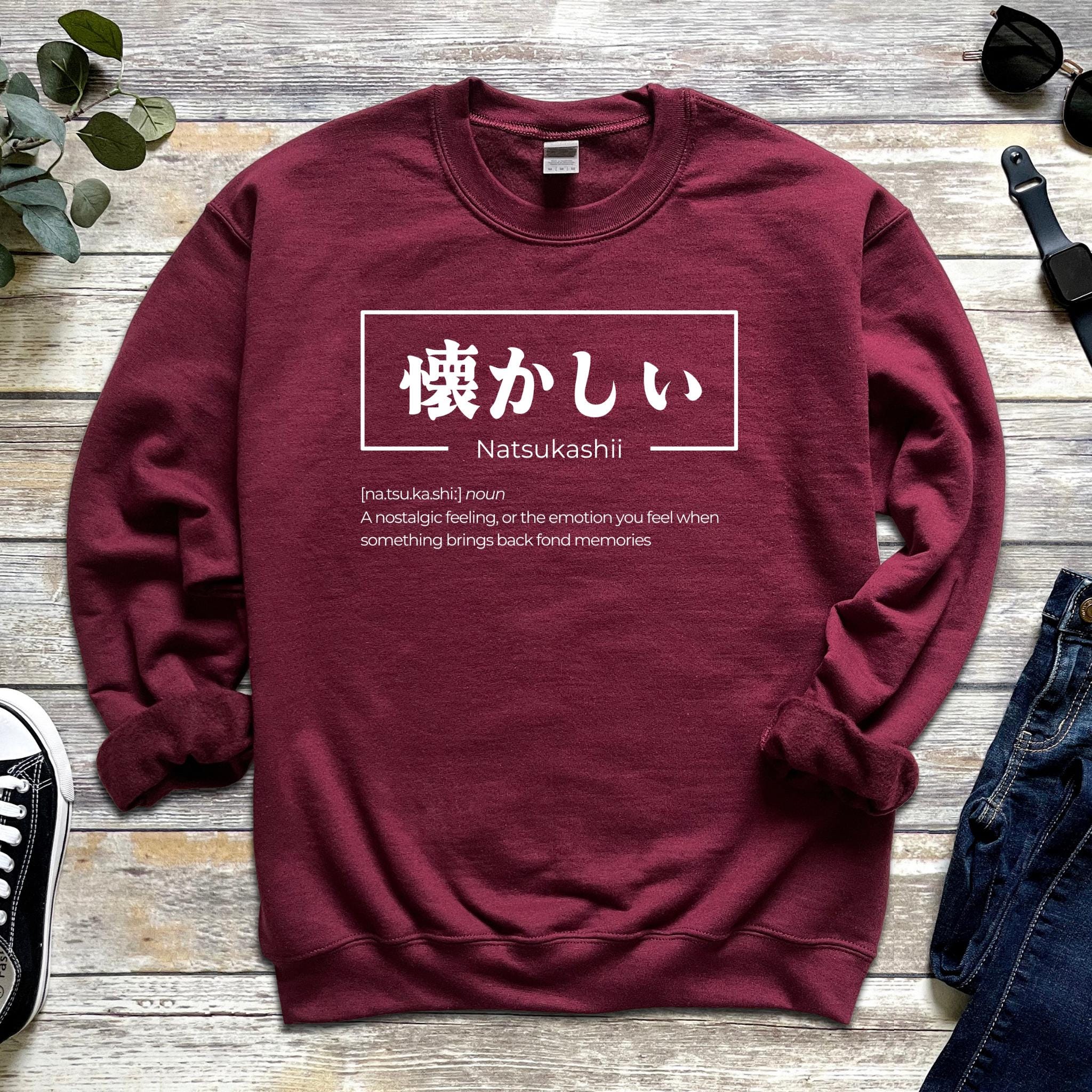 a red sweatshirt with japanese writing on it