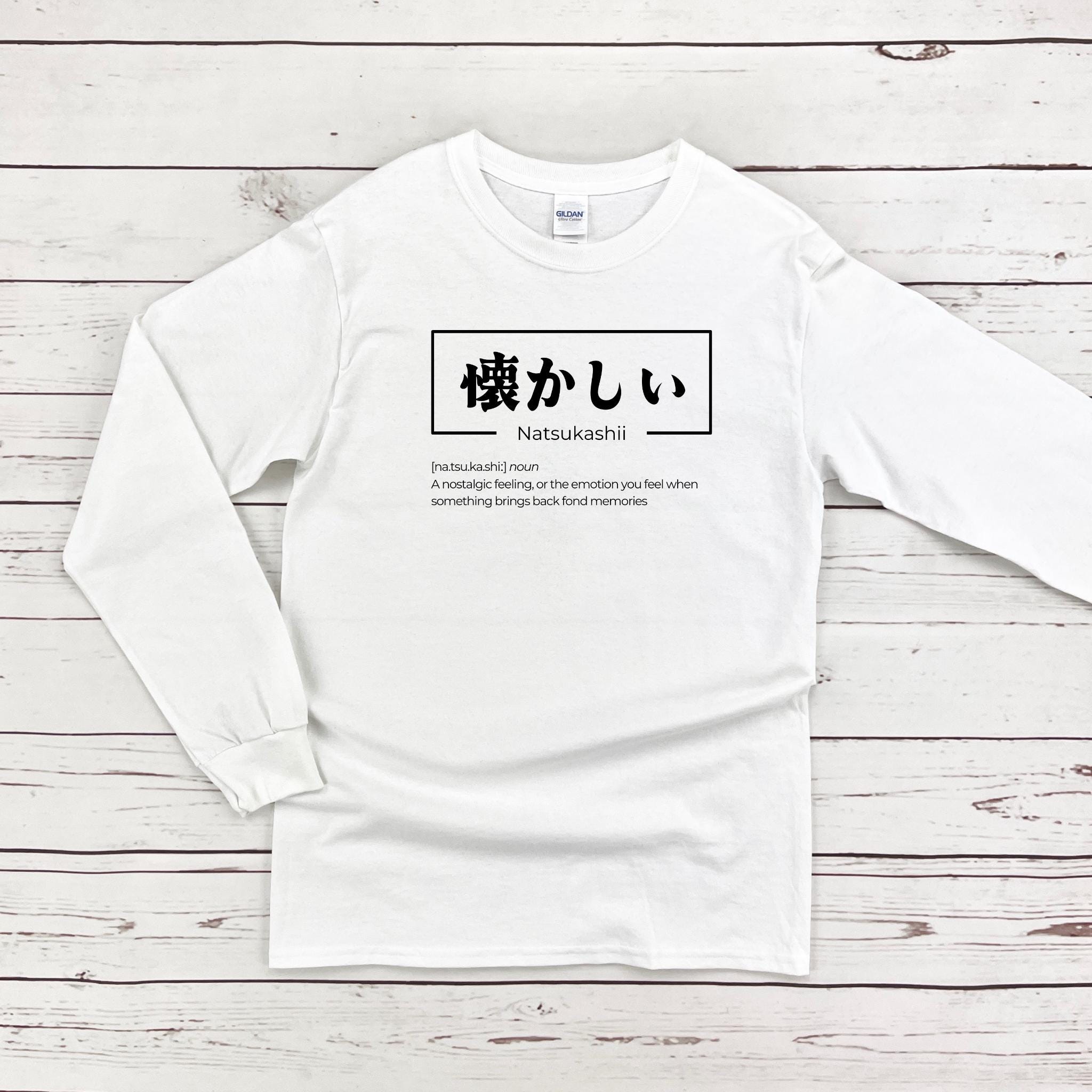 a white long - sleeved shirt with japanese characters on it