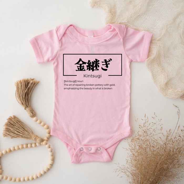 a baby bodysuit with chinese characters on it
