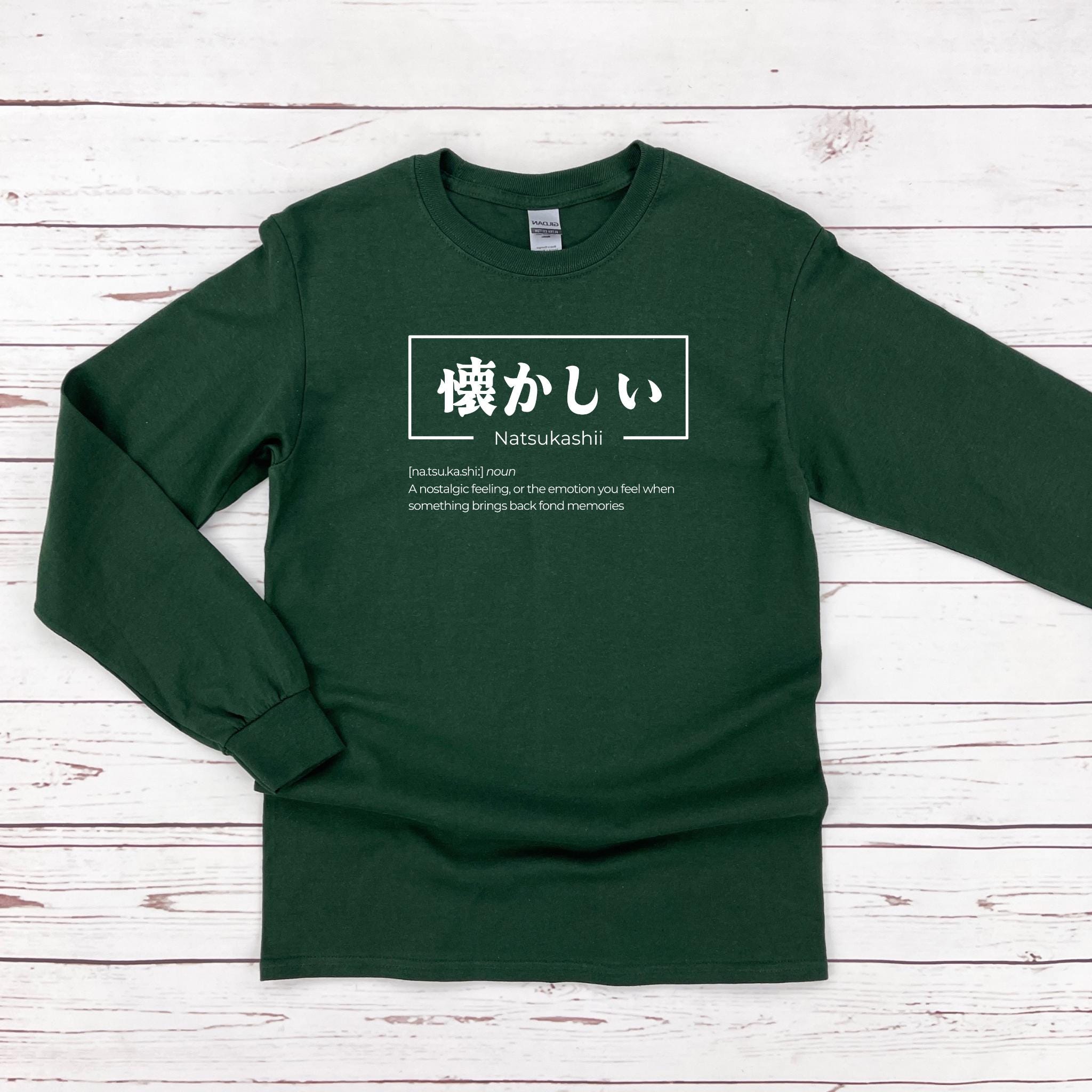 a green long - sleeved shirt with japanese characters on it
