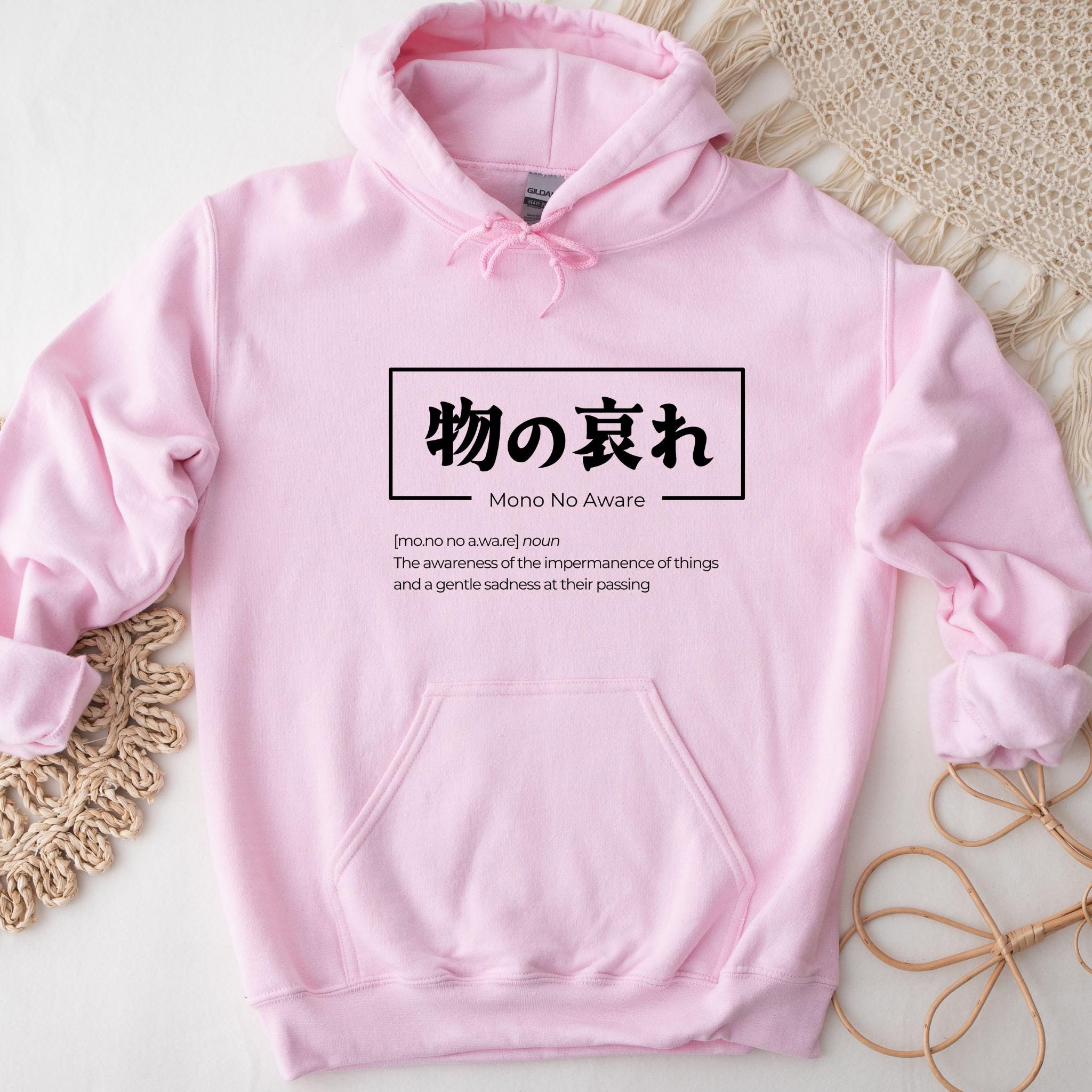 a pink hoodie with chinese writing on it
