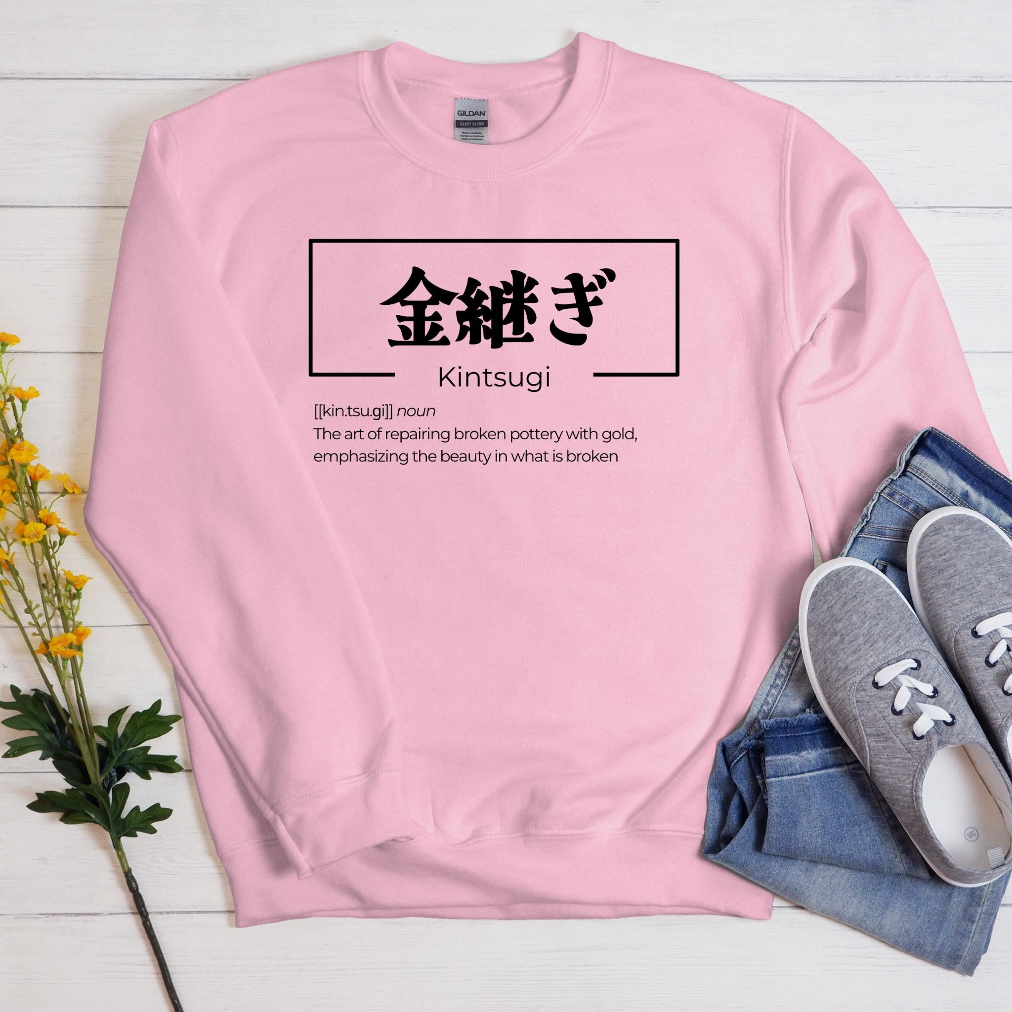 a pink sweatshirt with a japanese writing on it