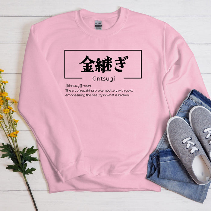 a pink sweatshirt with a japanese writing on it