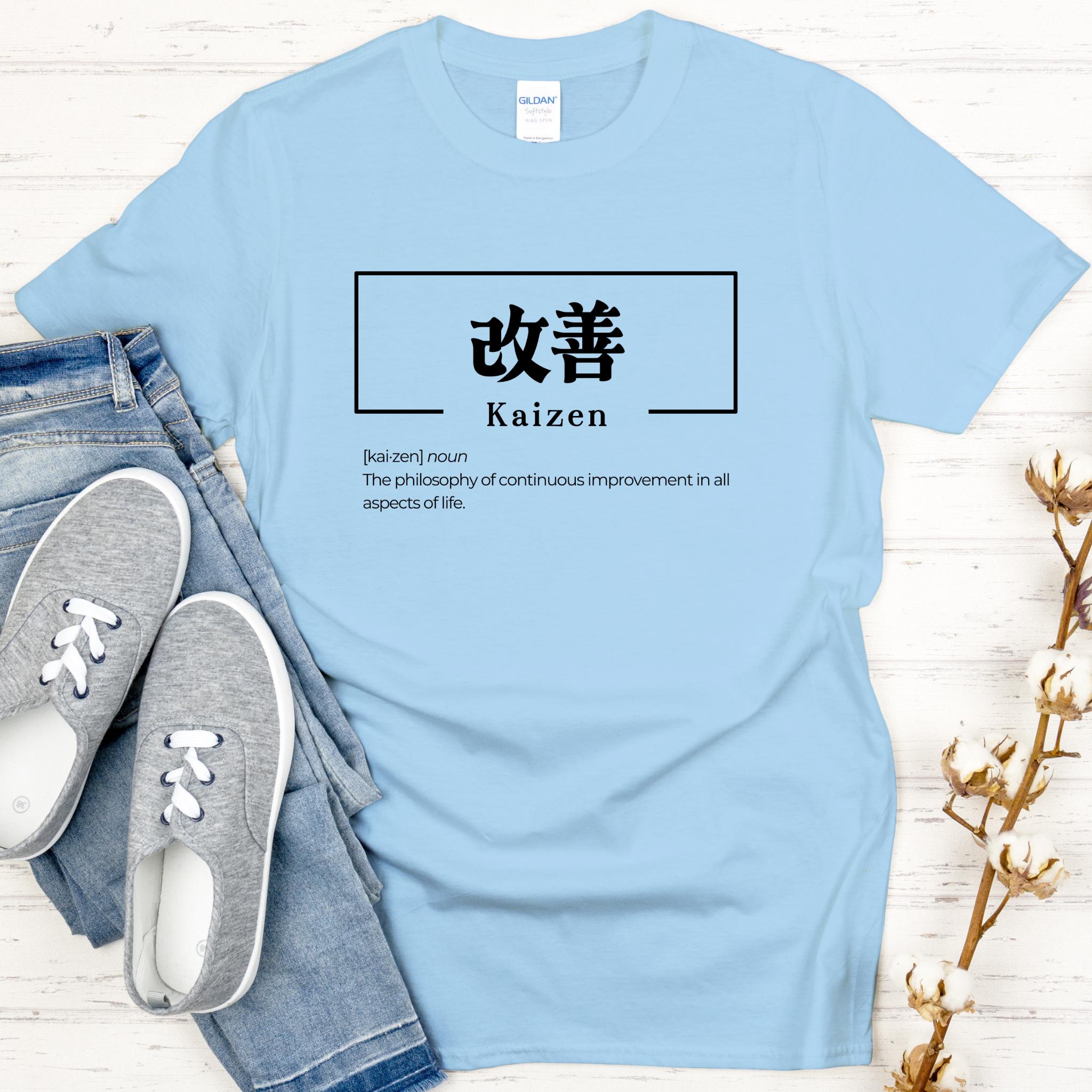 a t - shirt that says kaizen with a pair of shoes next to it