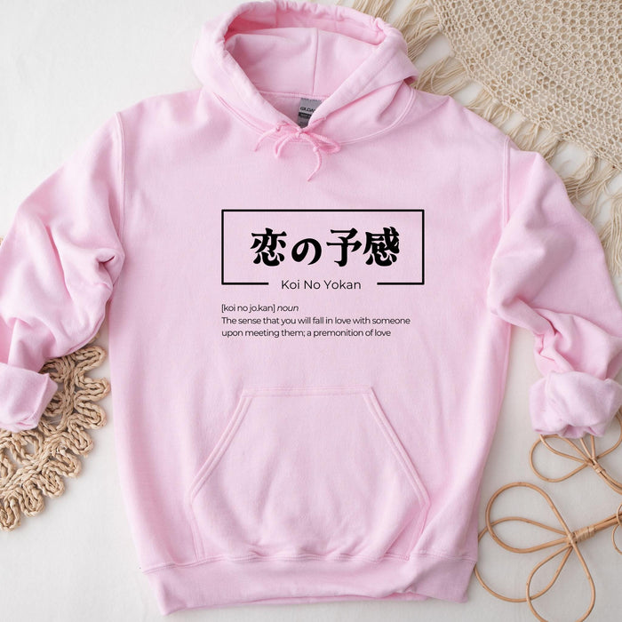 a pink hoodie with chinese characters on it