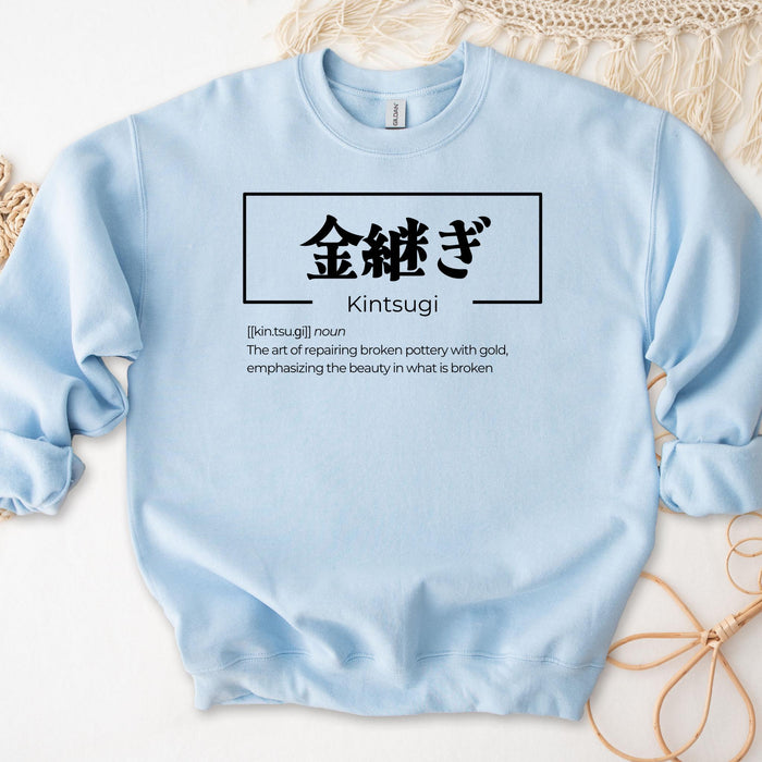 a light blue sweatshirt with the words kintsugi on it