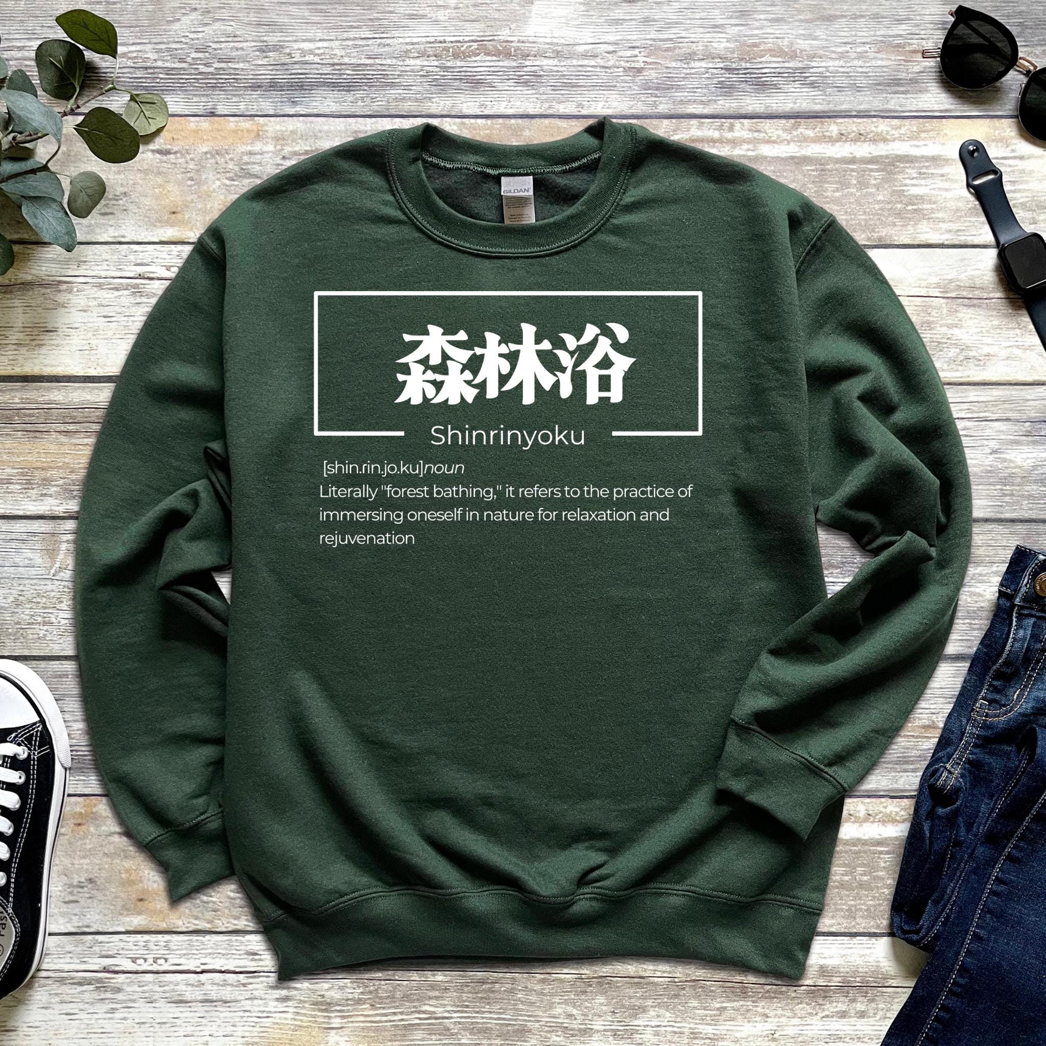 a green sweatshirt with chinese characters on it