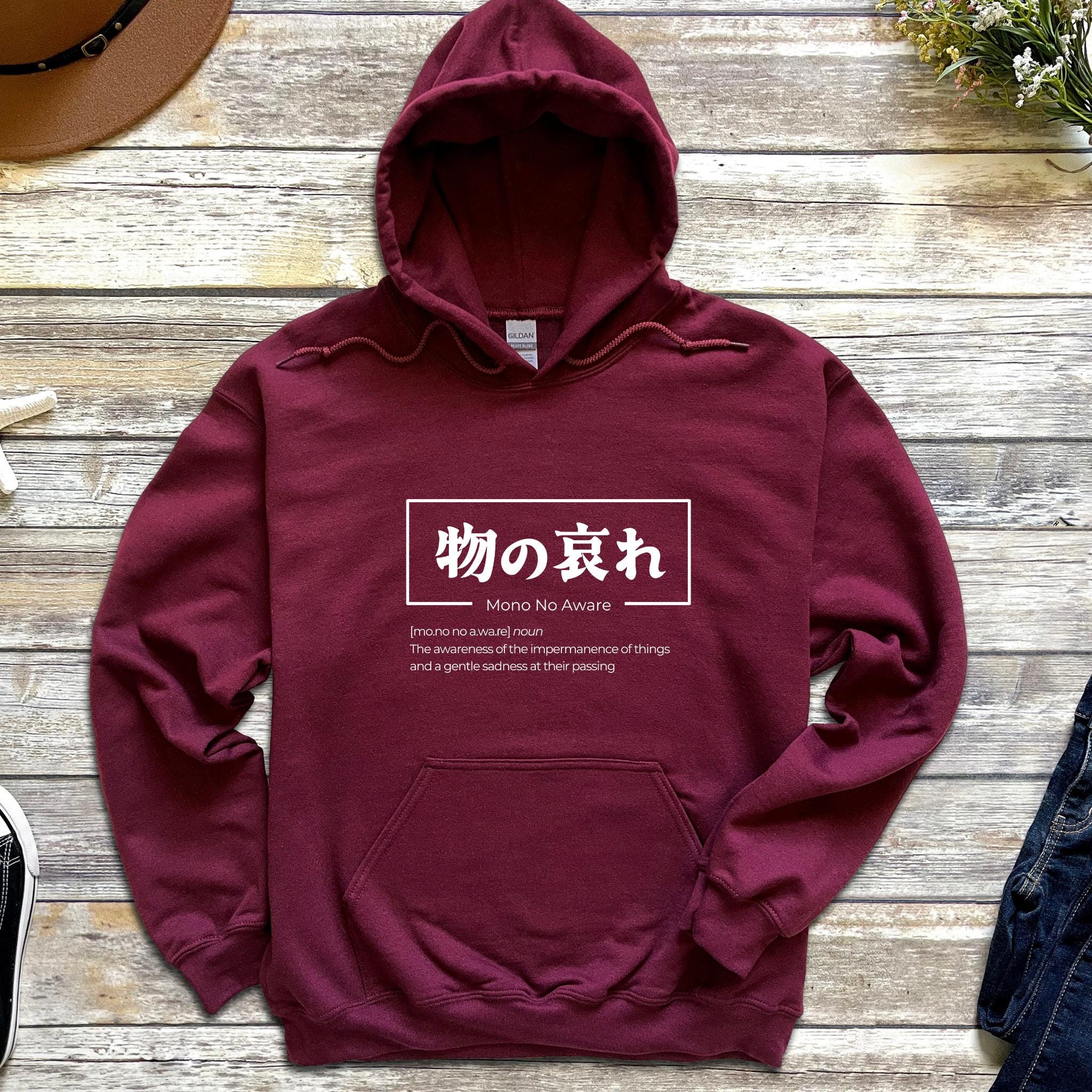 a maroon hoodie with japanese writing on it