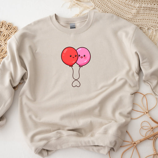 a sweater with a picture of two balloons on it