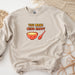 a sweatshirt with a bowl of soup and a spoon on it