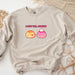a white sweatshirt with two donuts on it
