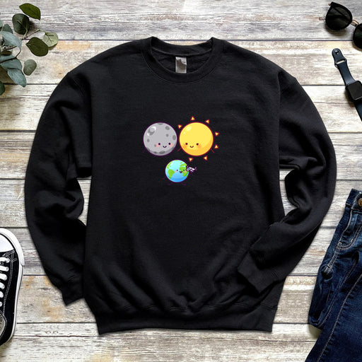 a black sweatshirt with the sun and moon on it
