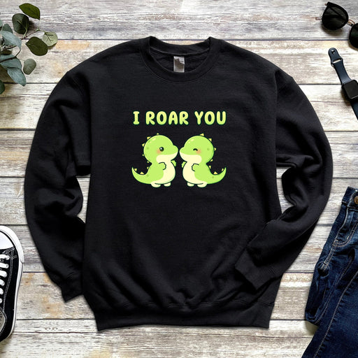 a black sweatshirt with two green dinosaurs saying i roar you