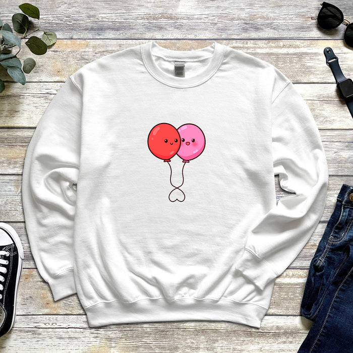 a white sweatshirt with two balloons on it