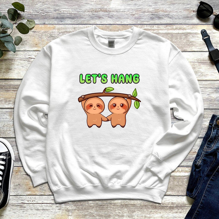 a white sweatshirt with two slots hanging from a tree