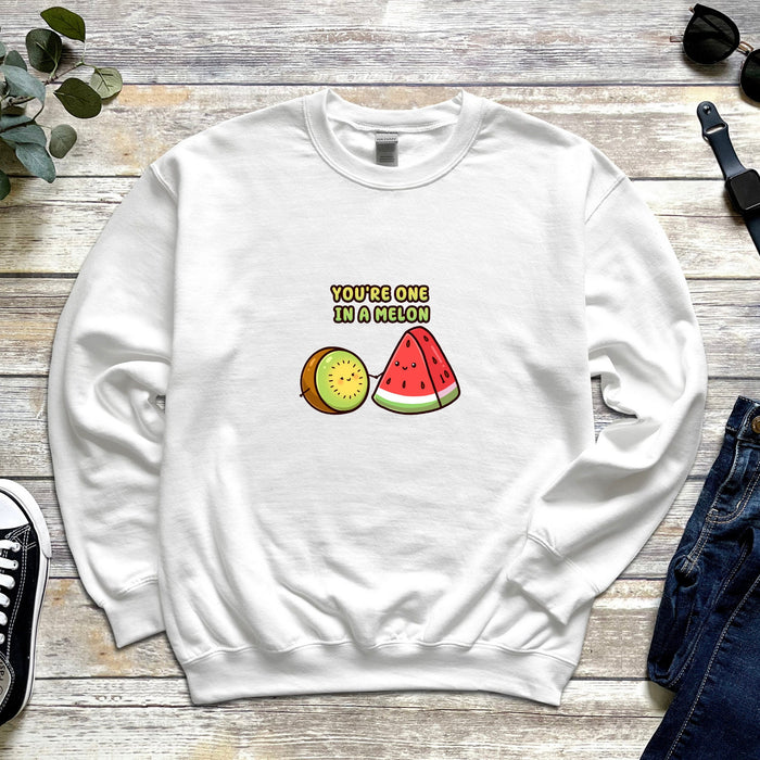 a white sweatshirt with a watermelon and kiwi on it