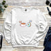 a white sweatshirt with coffee and donuts on it