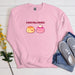 a pink sweatshirt with two donuts on it