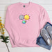 a pink sweatshirt with the sun and moon on it
