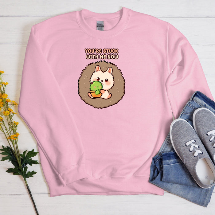 a pink sweatshirt with an image of a hedge holding a ball