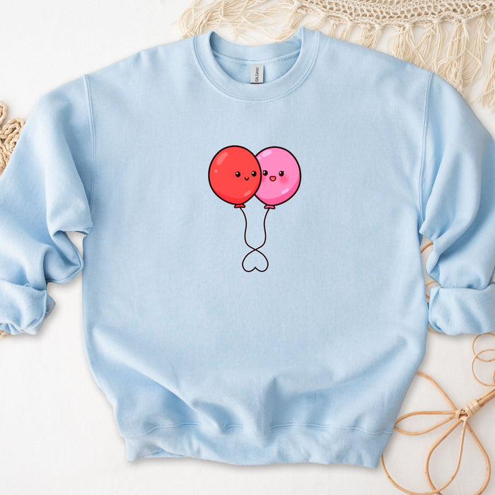 a blue sweatshirt with two balloons drawn on it