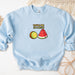 a blue sweatshirt with a watermelon and kiwi on it