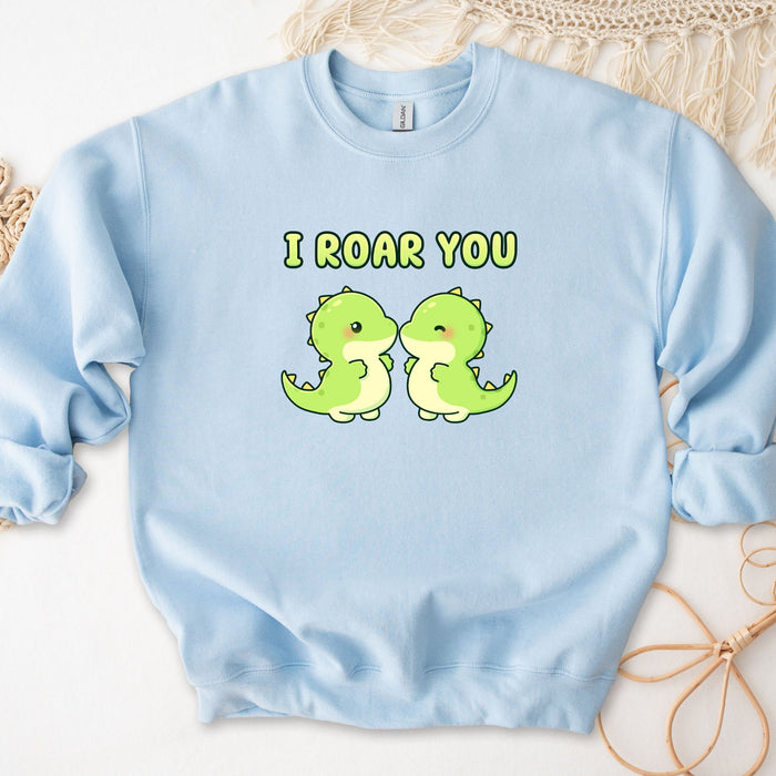 a blue sweatshirt with two green dinosaurs on it