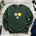 a green sweatshirt with an image of the earth and sun on it