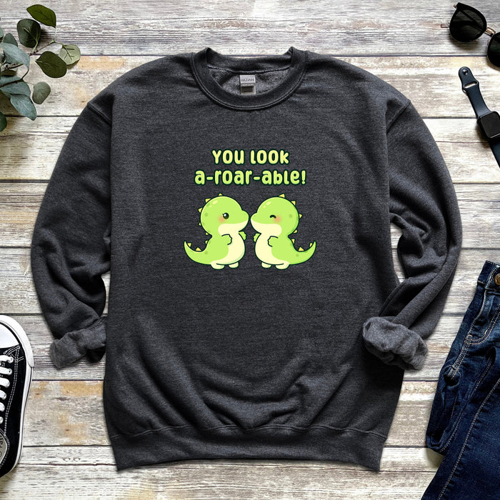 a sweatshirt with a couple of green dinosaurs on it
