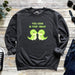 a sweatshirt with a couple of green dinosaurs on it