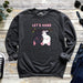 a sweatshirt with two cats hanging on a tree branch