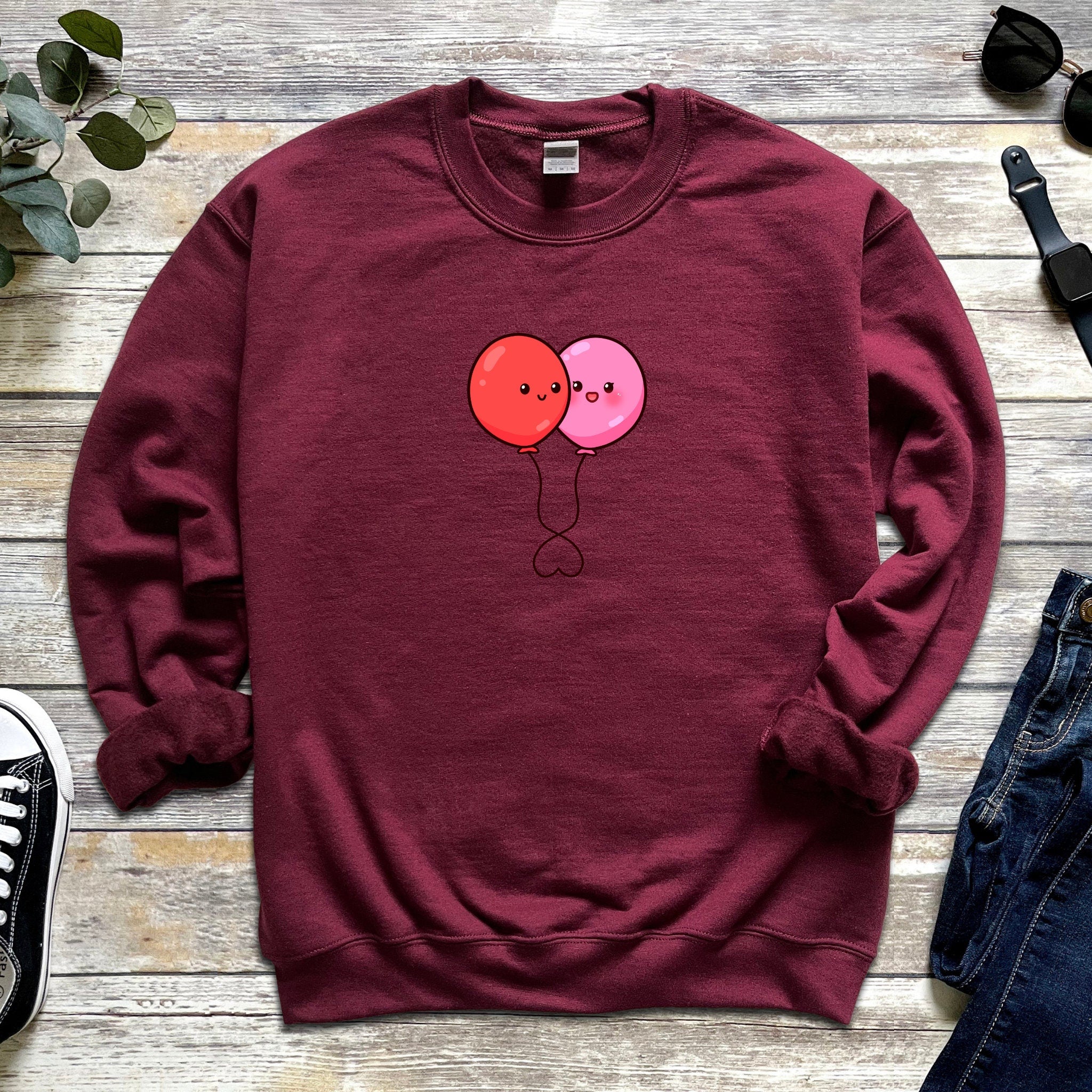 a red sweatshirt with two balloons on it