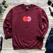 a red sweatshirt with two balloons on it
